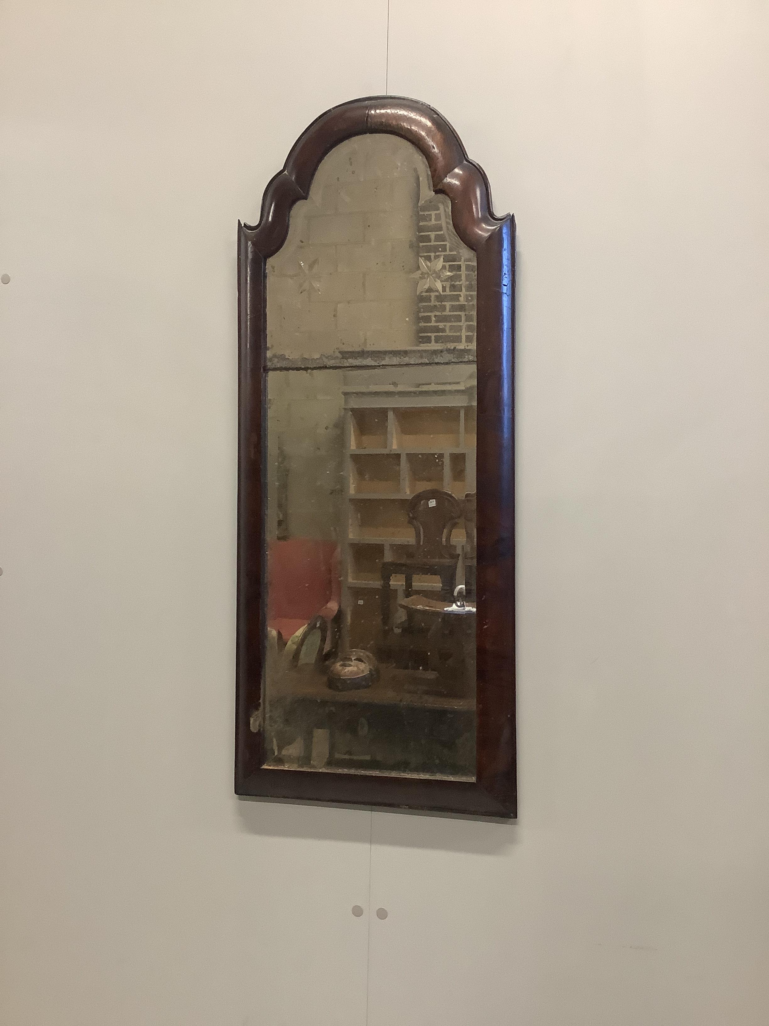 An early 18th century walnut cushion framed wall mirror, width 38cm, height 90cm